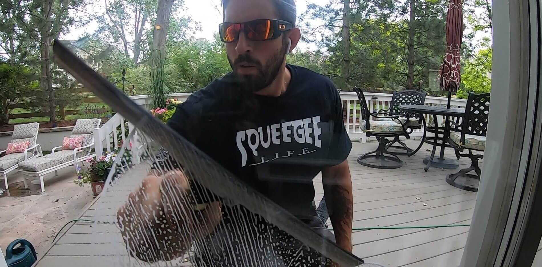 Man squeegeeing a window