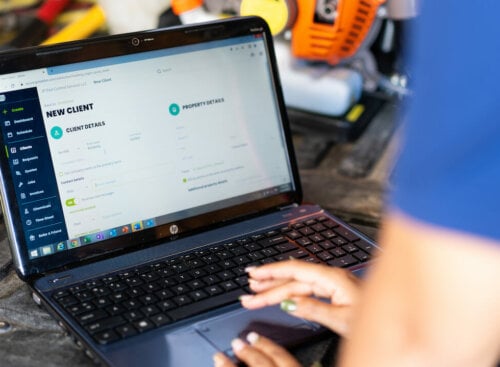 Photo of a service business owner adding a new customer to the Jobber CRM