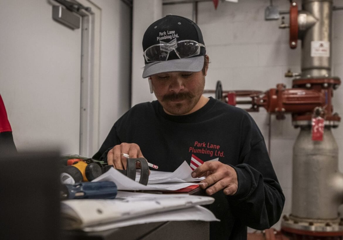 Quote, Estimate, Bid or Proposal? Service Professional looking at their paperwork