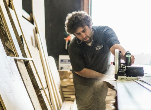 Photo of a contractor using a table saw in a workshop