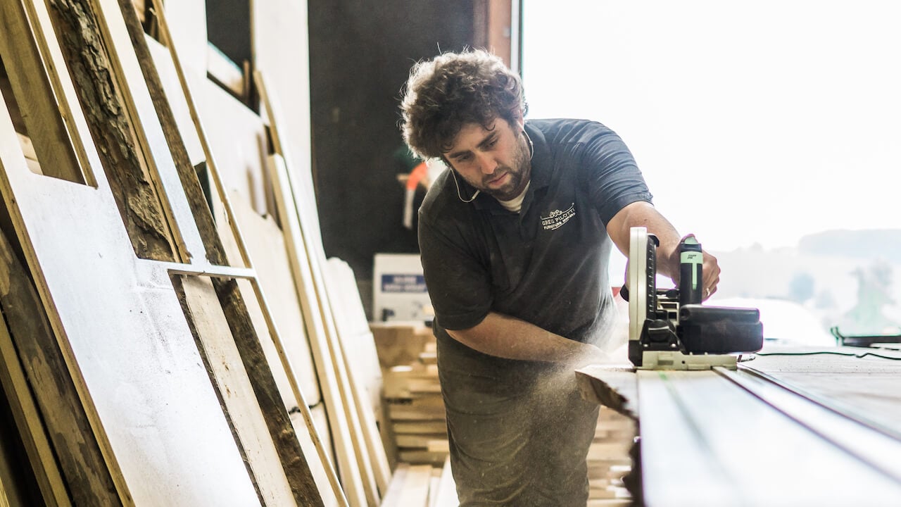 Photo of a contractor using a table saw in a workshop