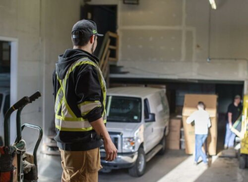 Photo of a field service contractor coordinating his team in a work garage