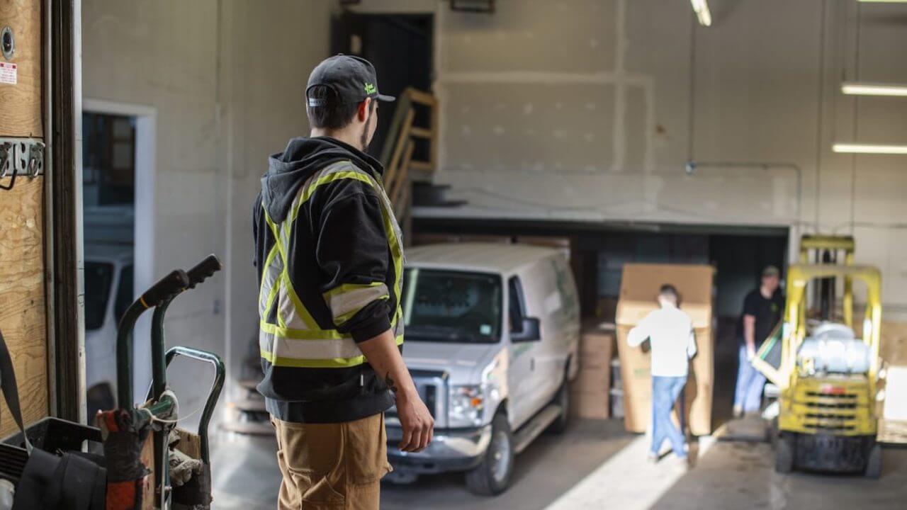 Photo of a field service contractor coordinating his team in a work garage