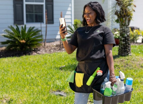 woman looking at phone and smiling