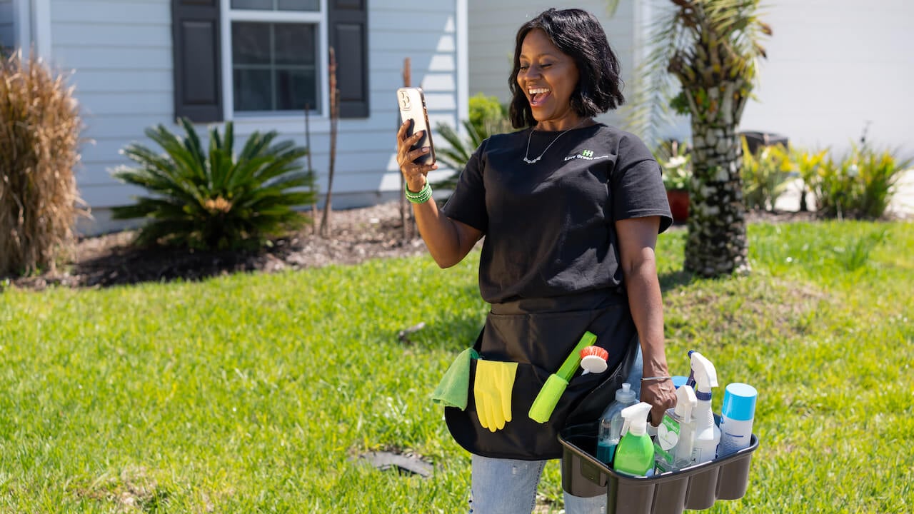 woman looking at phone and smiling