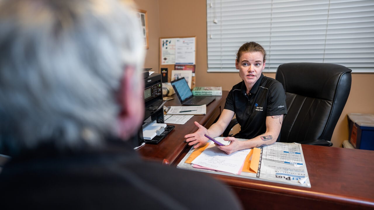 woman speaking to client across desk