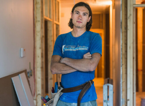 electrical worker standing in a framed home