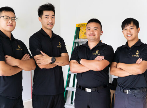 four plumbing employees standing in a line