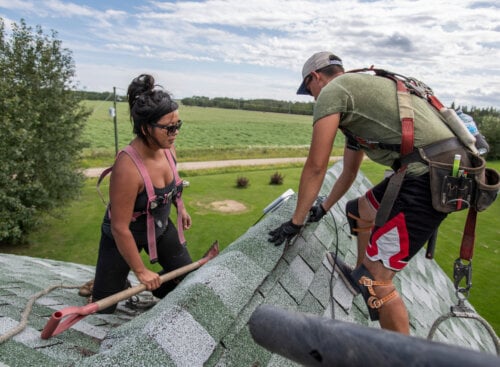 image of roofing contractors working on roof