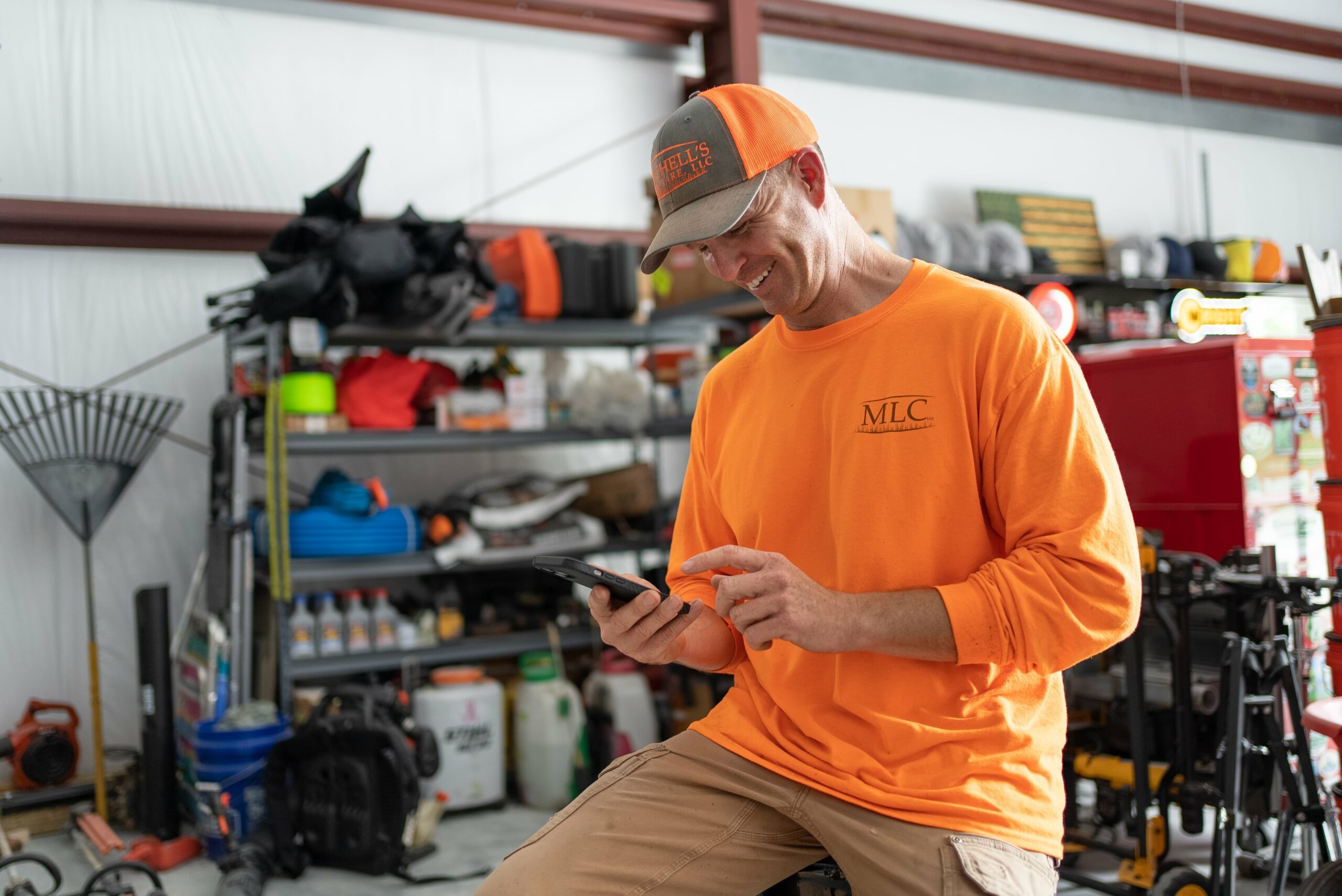 image of lawn care service provider working on mobile device
