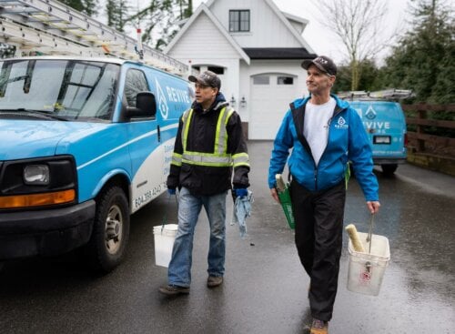 image of two members of Revive Washing on the job site with buckets