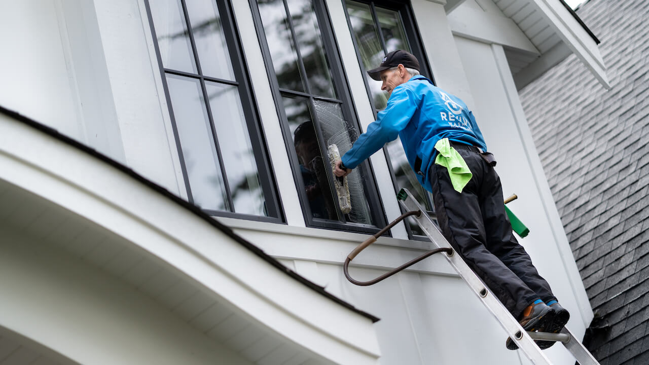 image of Revive Services washing a customer's window
