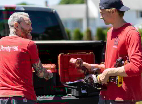 two handyman employees discussing handyman business names