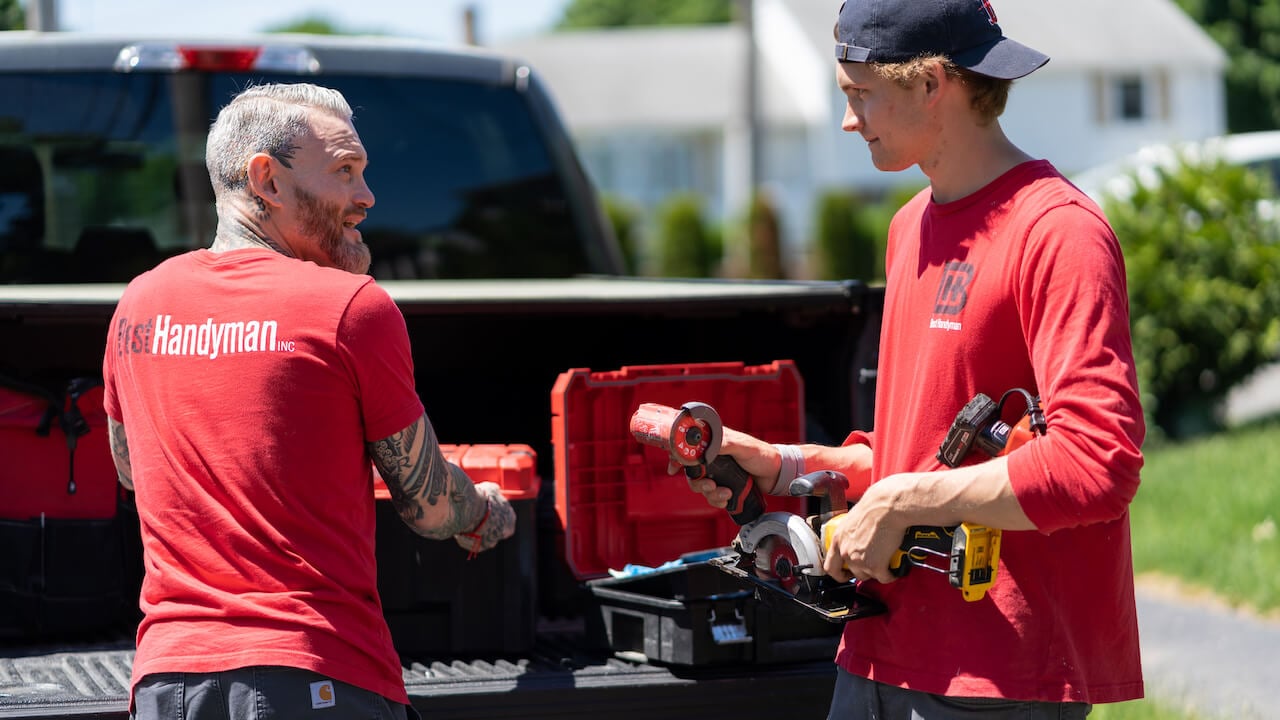 two handyman employees discussing handyman business names