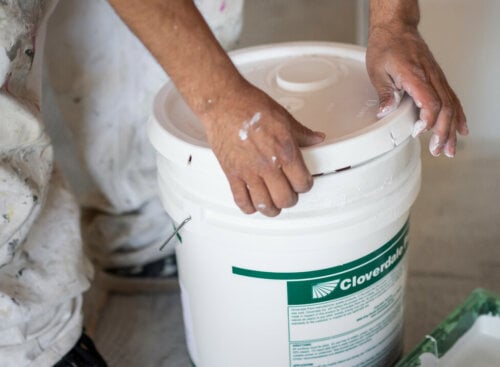 painting business names - man's hands opening a paint container
