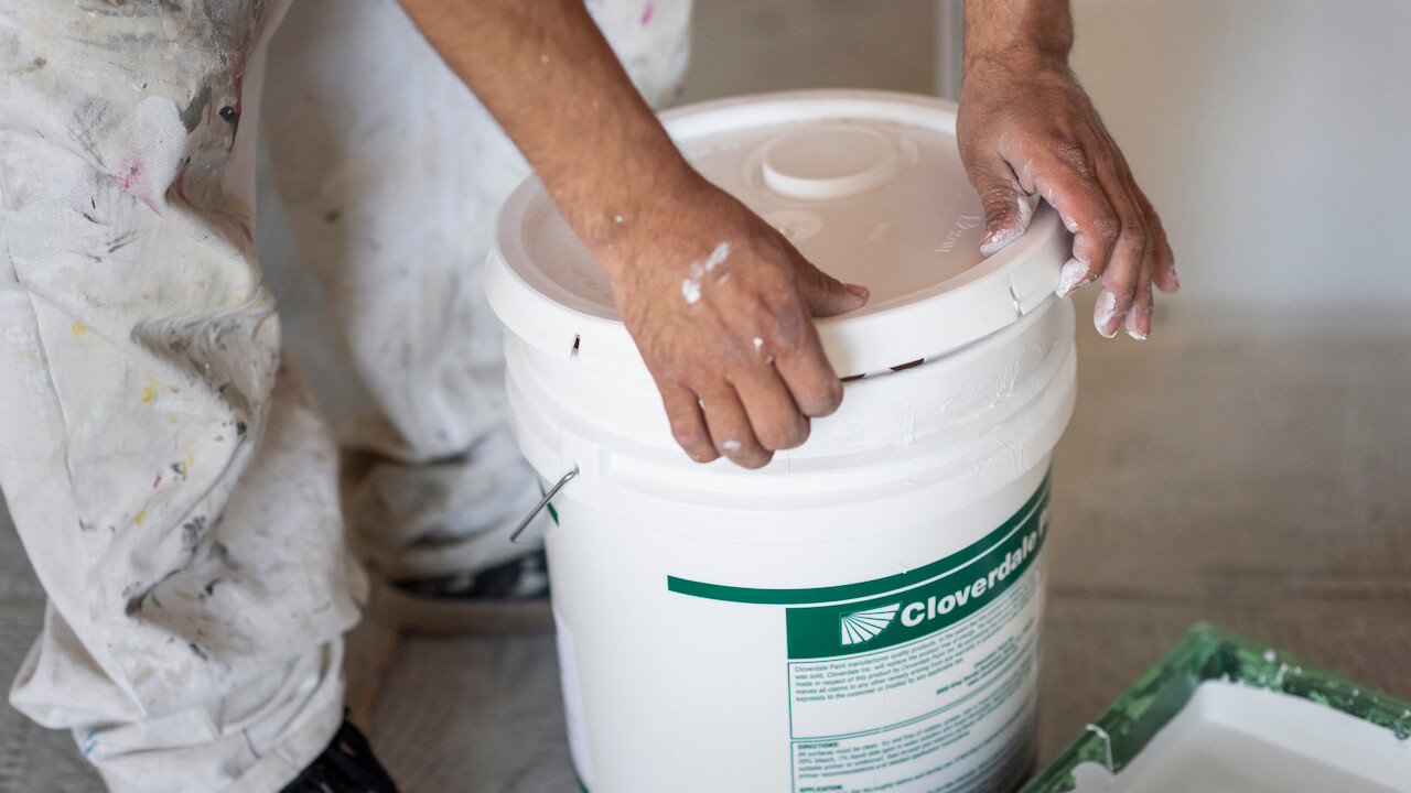 painting business names - man's hands opening a paint container
