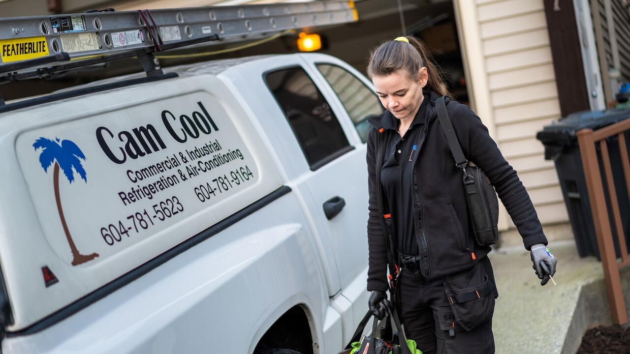 HVAC technician preparing for a service call assigned by an HVAC dispatcher