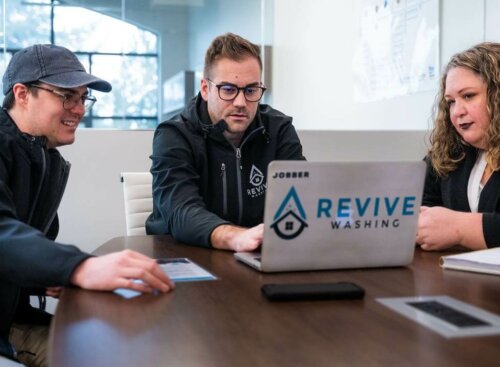 image of the Revive Washing Team working together on a laptop