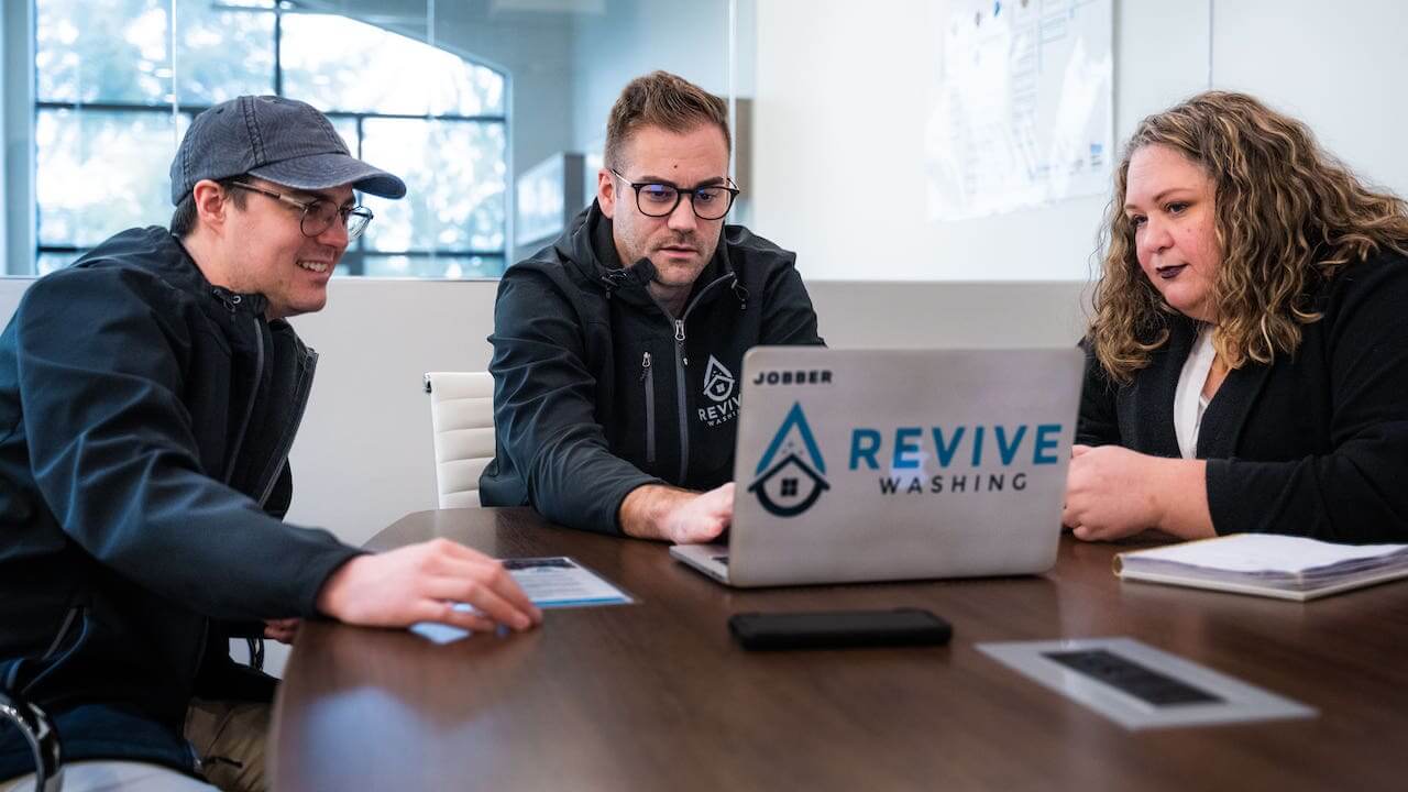 image of the Revive Washing Team working together on a laptop