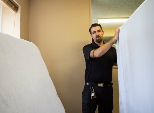 how to start a junk removal business - man moving mattress