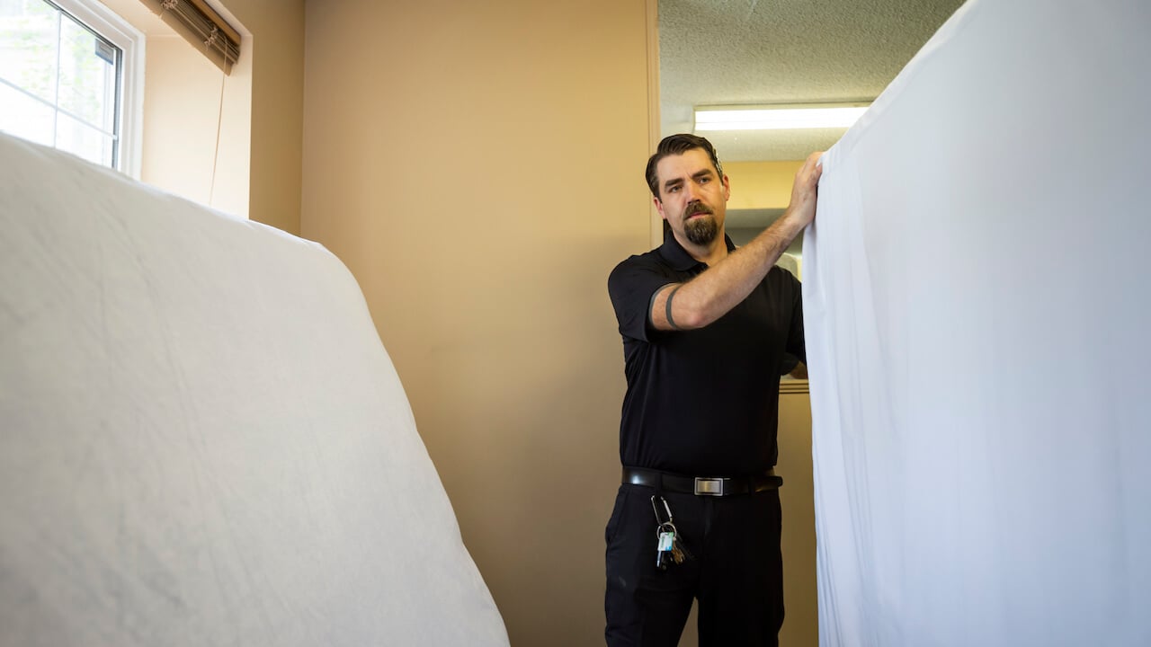 how to start a junk removal business - man moving mattress