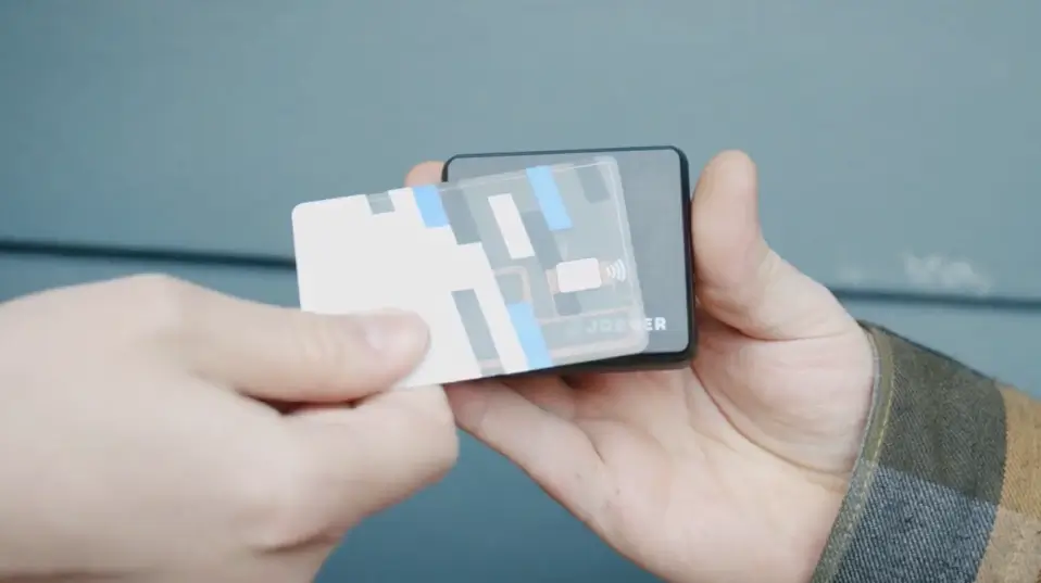 Business owner accepting a credit card payment with the Jobber Card Reader