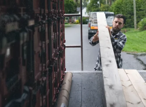 image of contractor unloading 2x4s after using general contractor business software