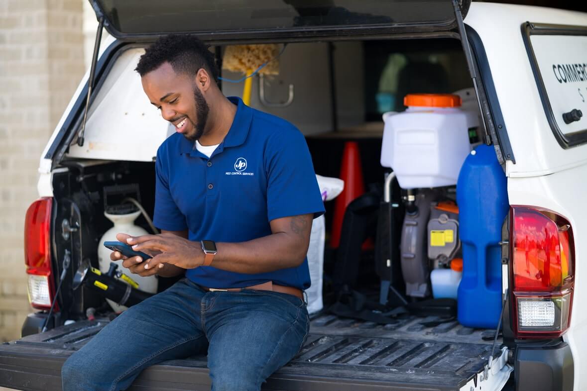 home service business owner using mobile software to manage business