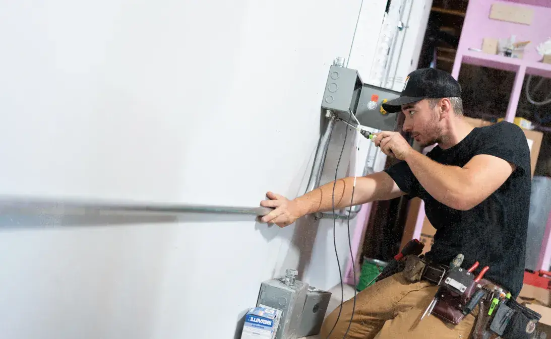 image of electrical contractor working on electrical panel after using Jobber's electrical contractor software