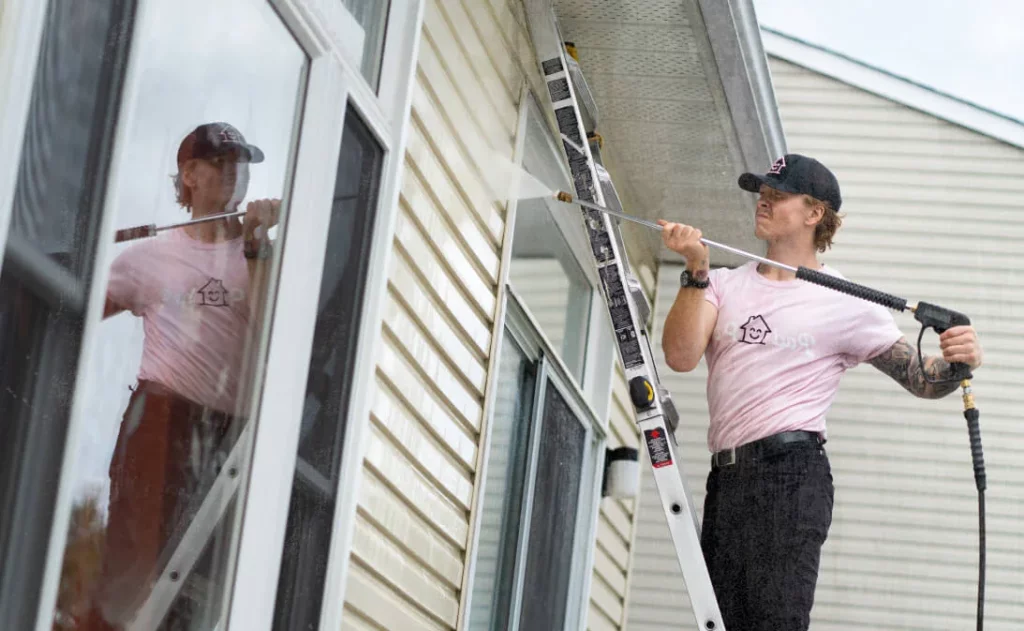 image of pressure washer cleaning a window after using pressure washing business software