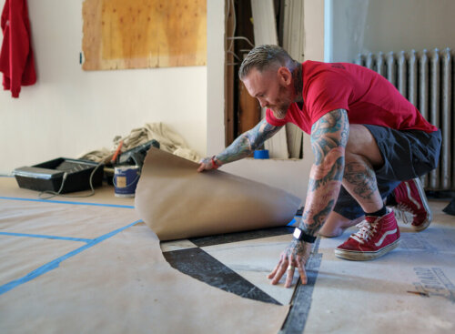 flooring company names - man removing paper wrapping from marble floor