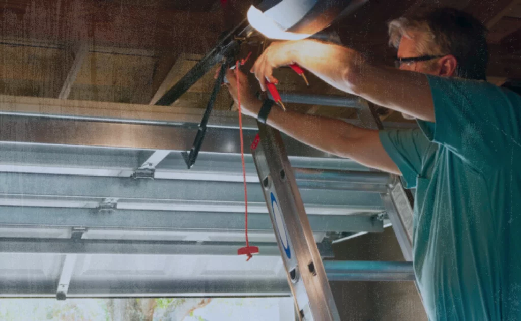 image of garage repair technician fixing a garage door after using Jobber