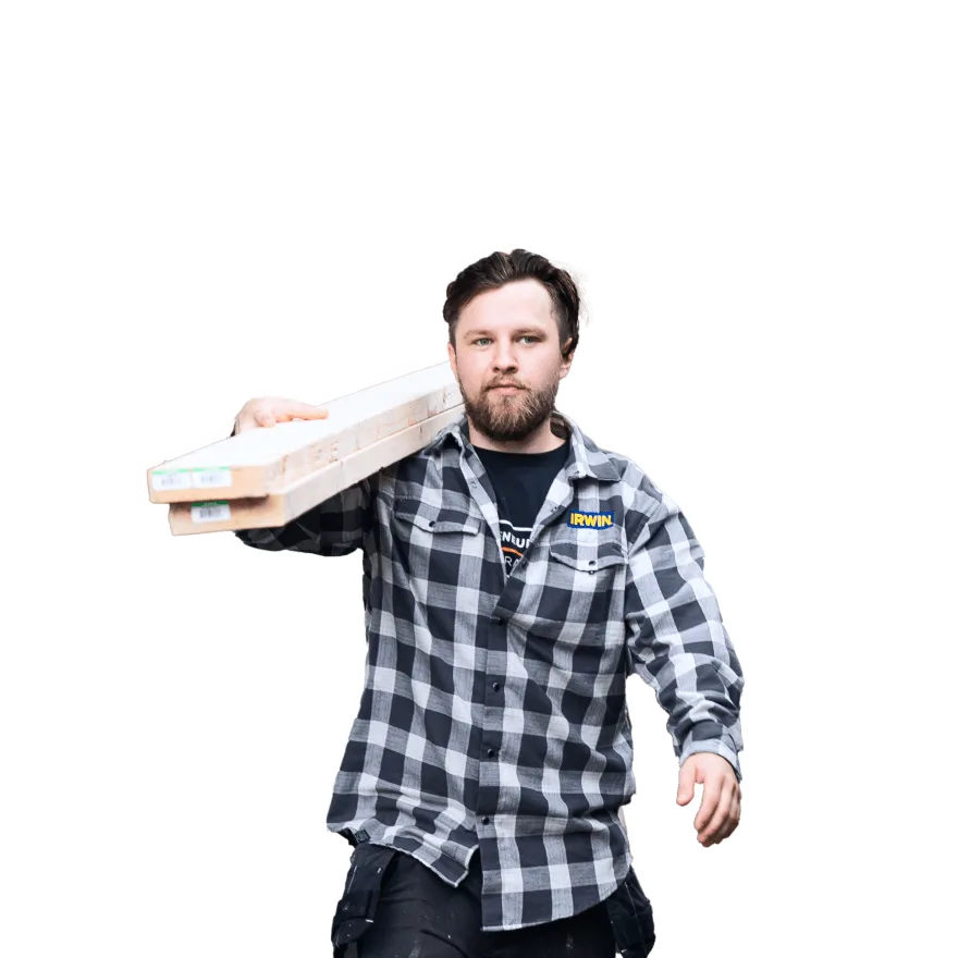 a man carrying 2 wooden boards