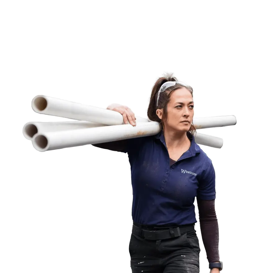a woman carrying PVC pipes on her shoulder