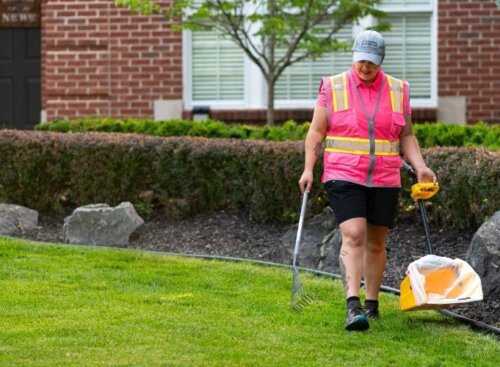 Pooper scooper technician scooping pet waste at resident's home