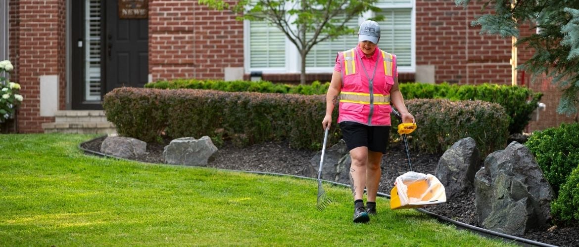 Pooper scooper technician scooping pet waste at resident's home