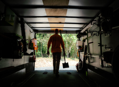 A lawn care worker leaving his truck for recurring services.