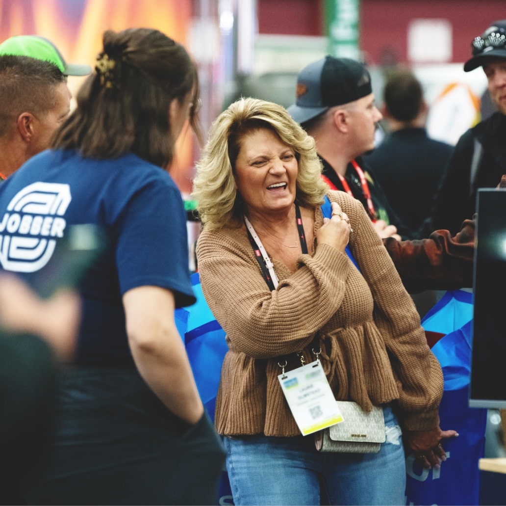 A woman laughing during a casual conversation.