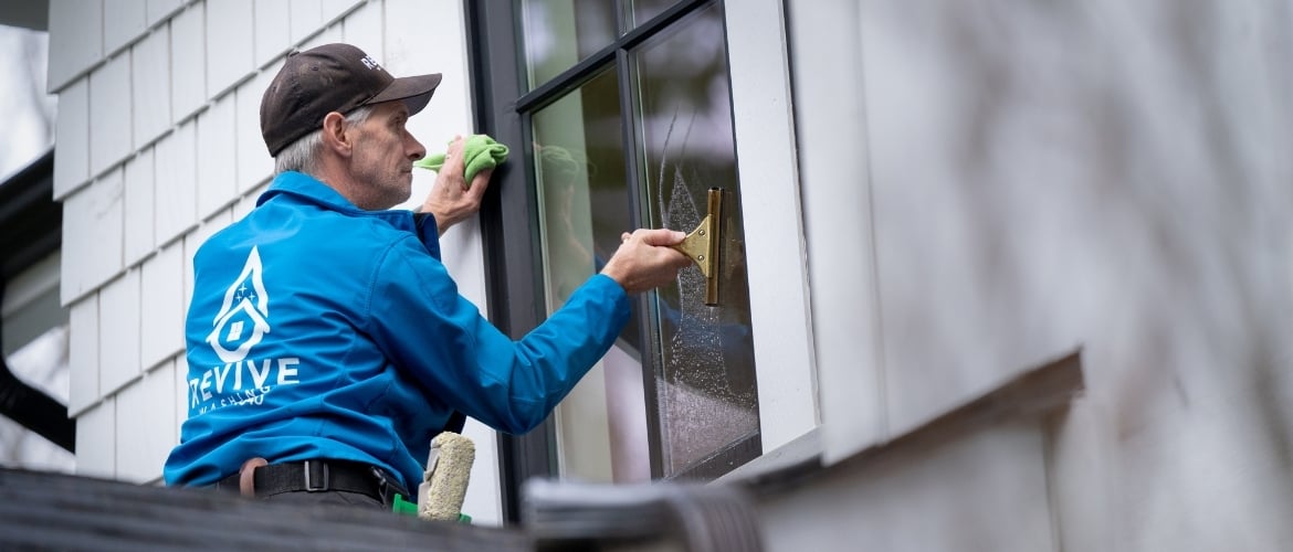 Man window cleaning a resident's home