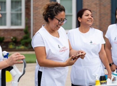 Group of residential cleaners standing outside resident's home