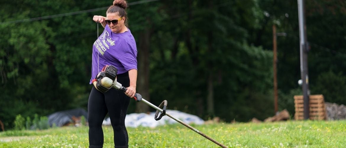 Lawn care technician starting up string trimmer