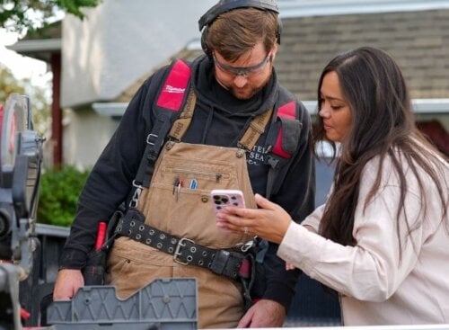 Contractor SP at job site using mobile device to manage business operations