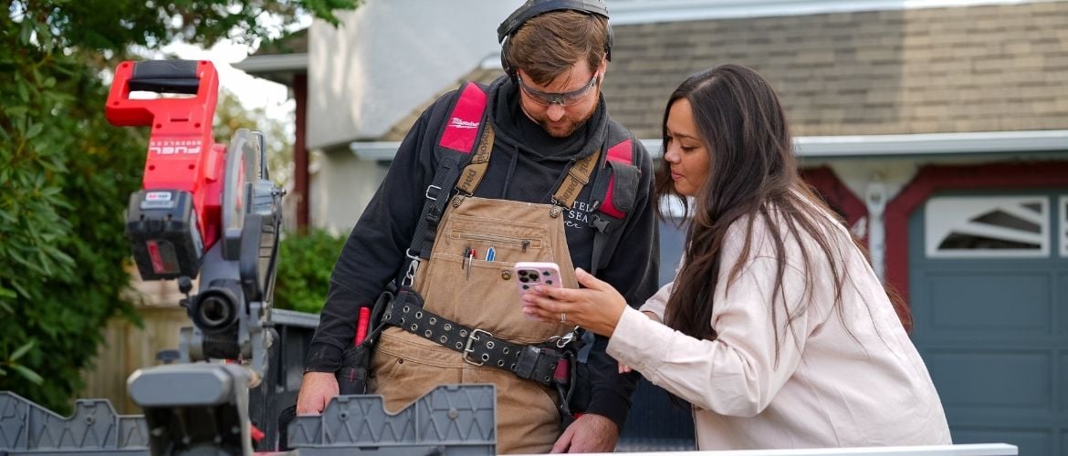 Contractor SP at job site using mobile device to manage business operations