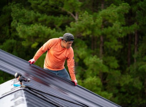 image of roofer laying materials.