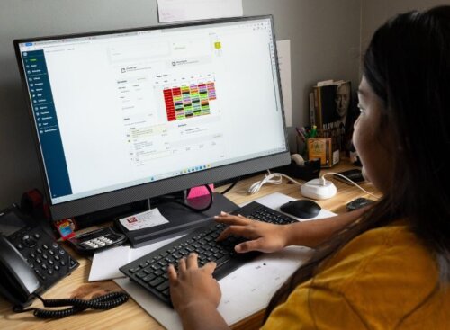 Cleaning service provider using Jobber on their computer to manage business operations
