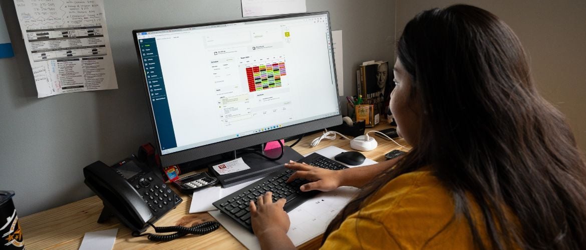 Cleaning service provider using Jobber on their computer to manage business operations