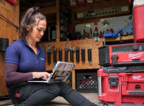 Service provider using software on their laptop to manage business operations