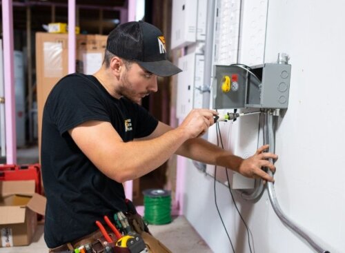 Electrician on the job. Learn about how you can make as an electrician in this article.