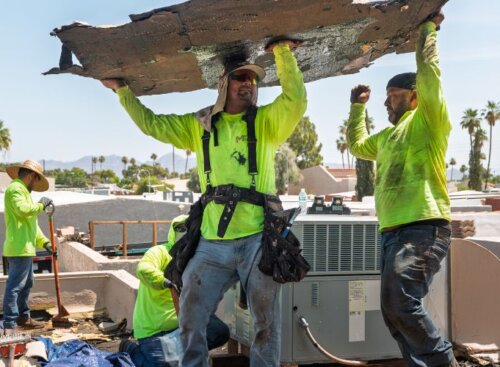 Roofing service providers removing old roof materials