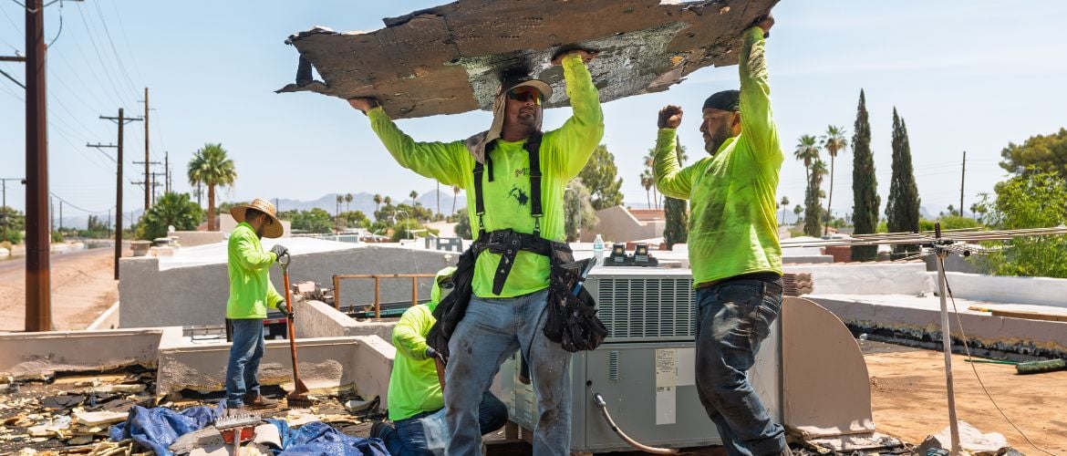 Roofing service providers removing old roof materials